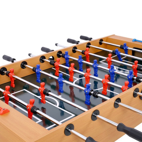 Close-up of a foosball table with red and blue player figures on a white background