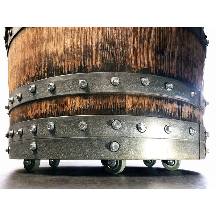 Wooden barrel with metal bands and wheels on a white background