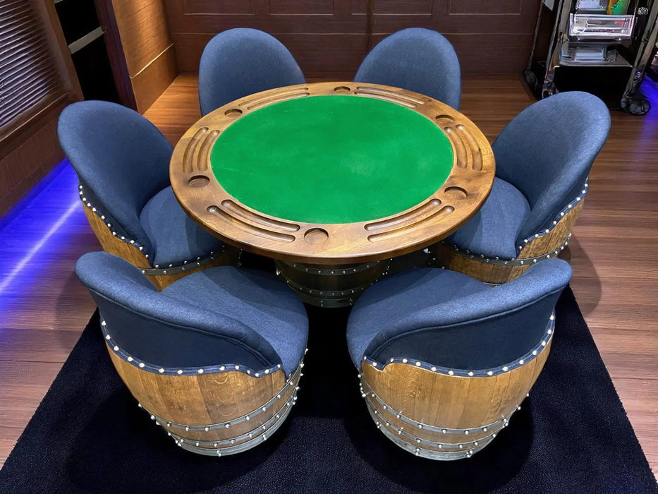 Wooden poker table with green felt surface surrounded by six blue chairs on a wooden floor.