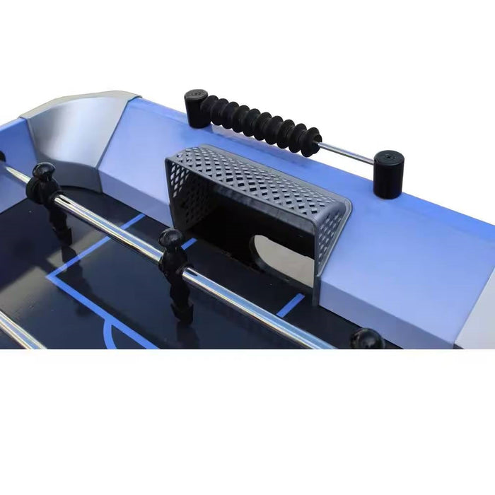 Close-up of a foosball table with metal rod and black ball