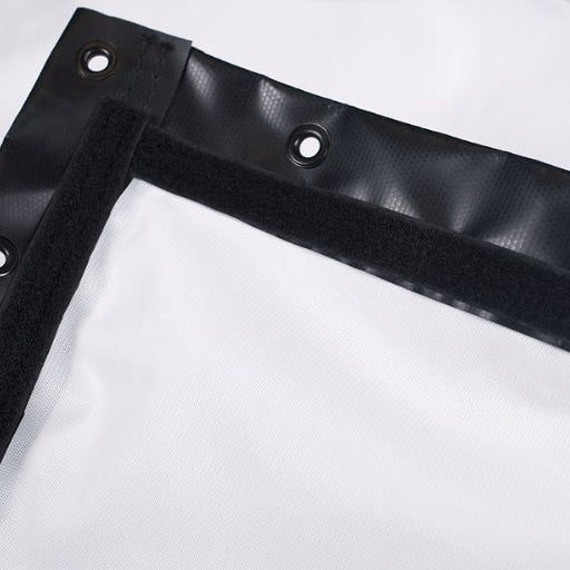 Black corner of a white tarp with grommets on a white background