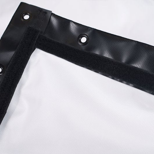 Black corner of a white tarp with grommets on a white background