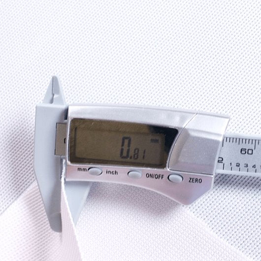 Digital caliper on a white fabric background