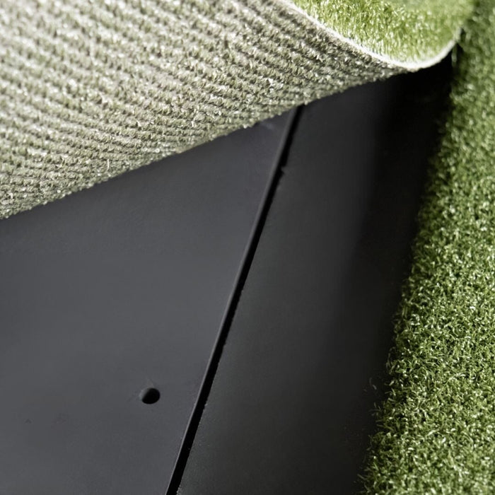 Black rectangular object on a textured green surface