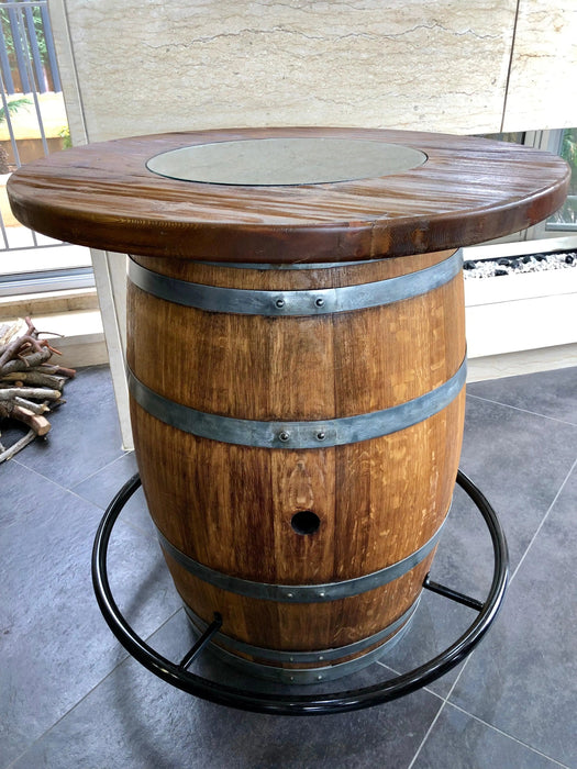 Wooden barrel table with metal bands on a concrete floor.