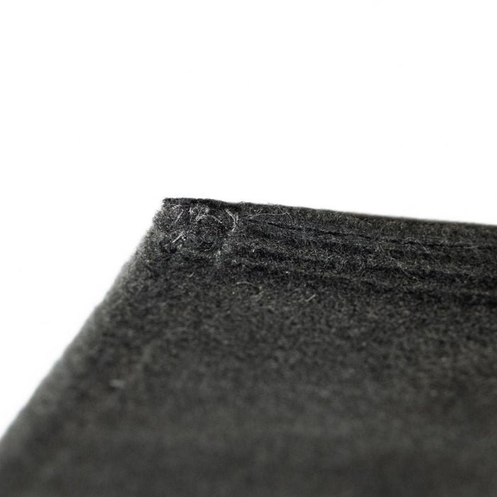 Close-up of a black filter with texture details on a white background