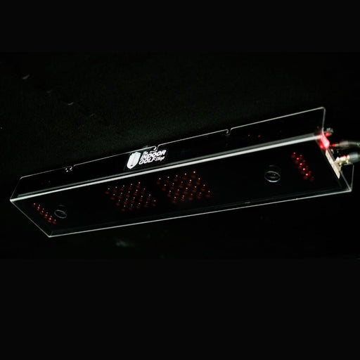 Clear electronic device with red lights on a black background