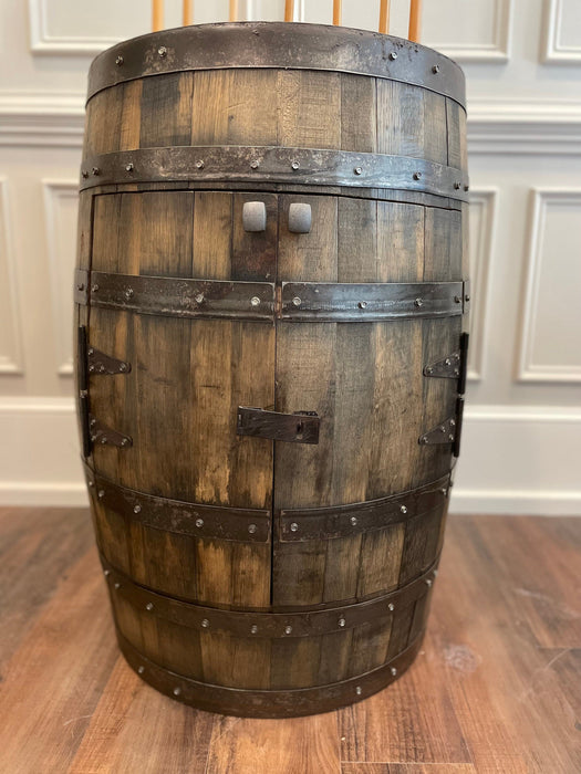 Wooden barrel with metal bands on a wooden floor