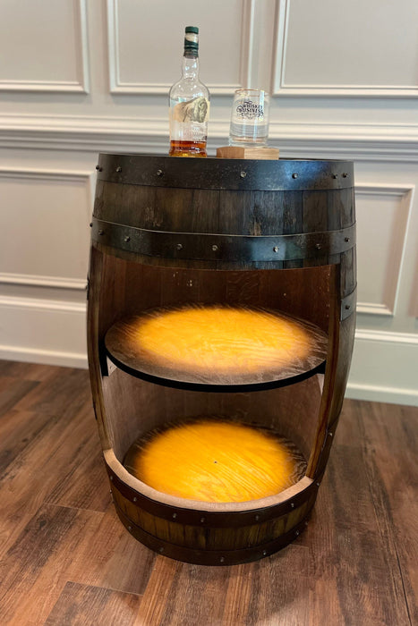 Wooden barrel with a bottle on top in a room setting