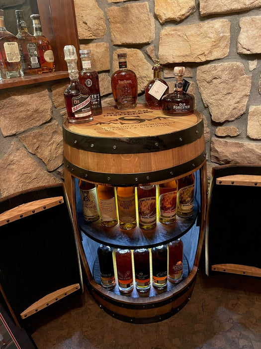 Wooden barrel shelf with whiskey bottles against a stone wall.