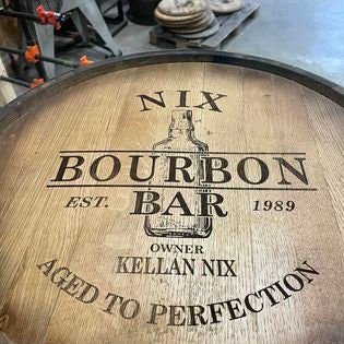 Wooden barrel with 'Nix Bourbon Bar' branding and text.