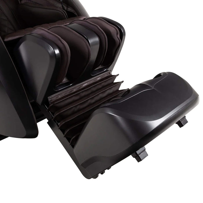 Close-up of a massage chair with a footrest on a white background
