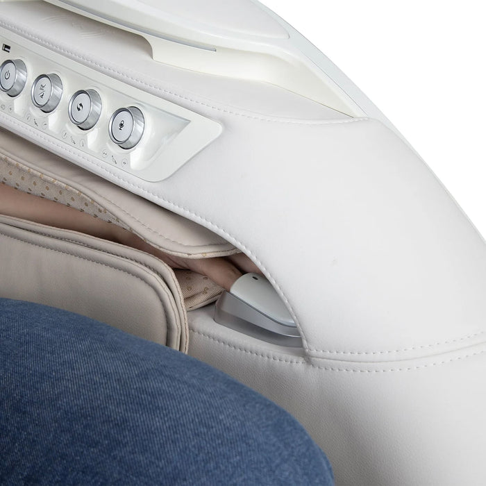 Close-up of a massage chair with control panel and person wearing blue jeans.