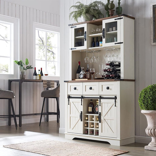 White bar cabinet with wine bottles and glasses in a home setting