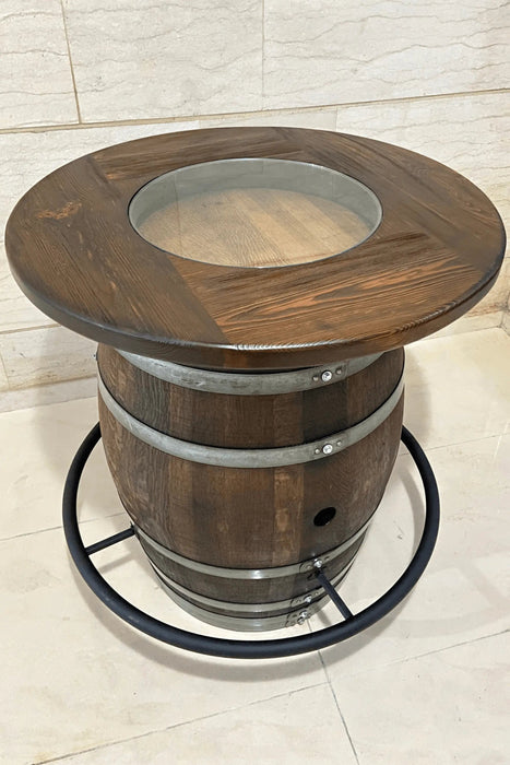 Wooden barrel table with glass top on a tiled floor