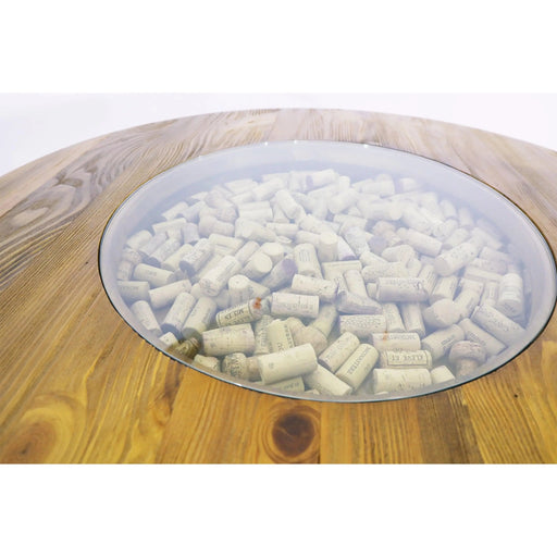 Glass bowl filled with wine corks on a wooden surface