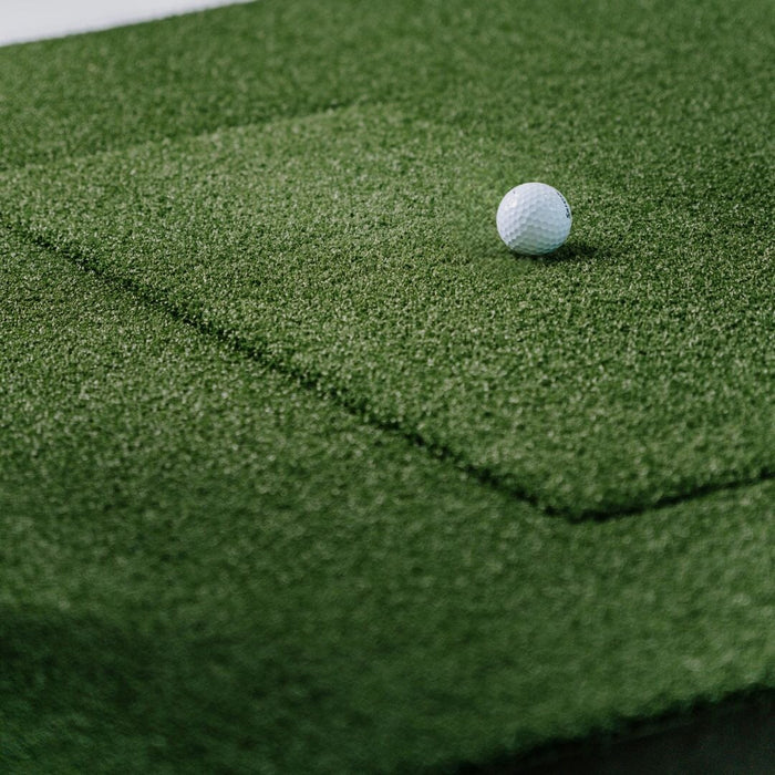 Golf ball on a green practice mat