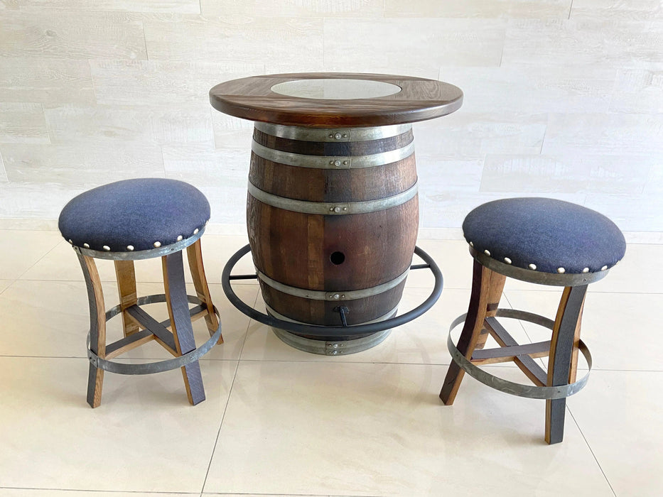 Barrel table with two stools on a light background