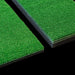Two green artificial grass tiles on a black background