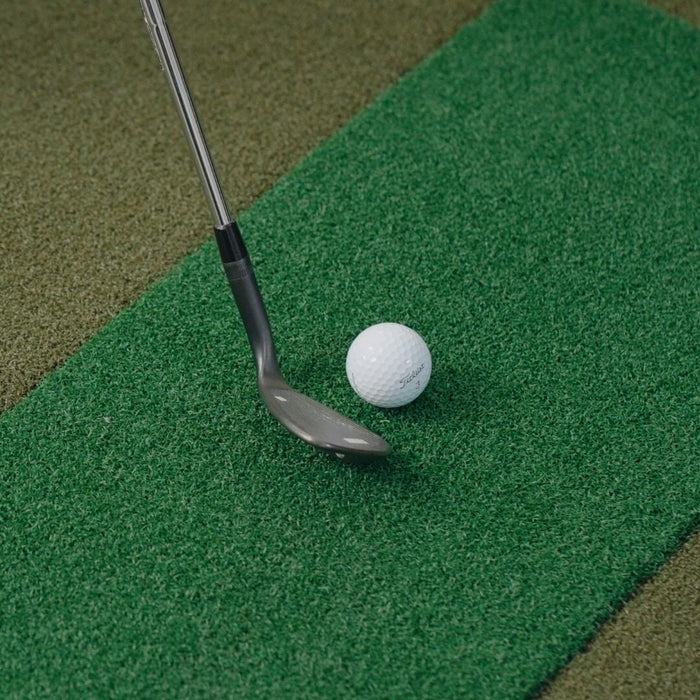 Golf club and ball on a green putting surface