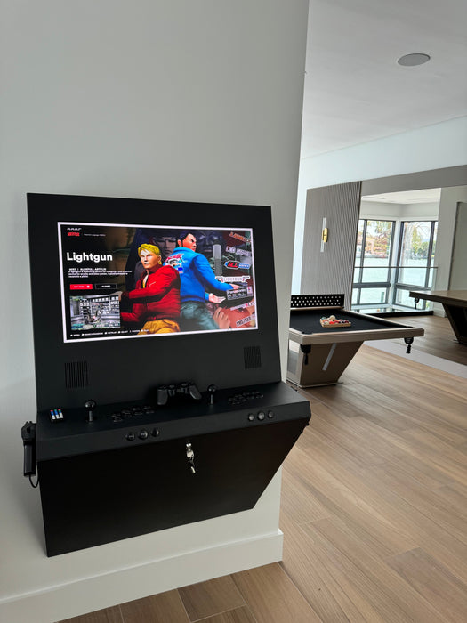 Black entertainment console with screen displaying a video game in a room with wooden flooring.