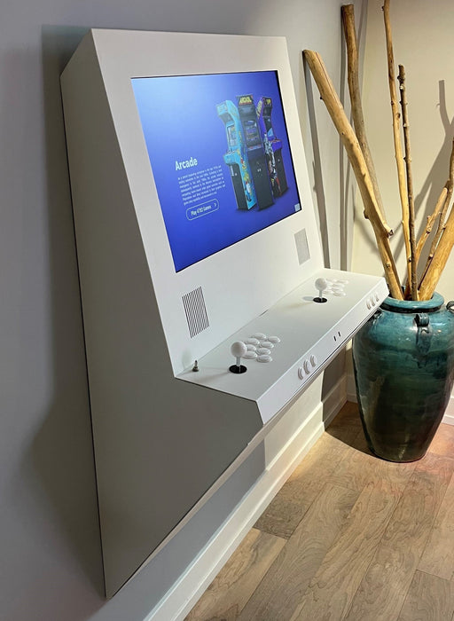 Wall-mounted interactive kiosk with a screen displaying an app interface, next to a vase with dried plants.