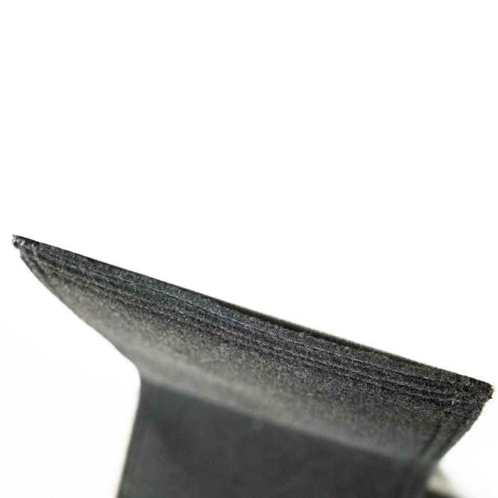Close-up of a textured black object on a white background