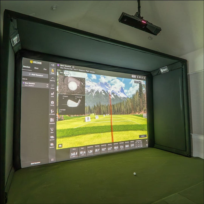 Golf simulator setup with screen displaying a golf course and a projector above.