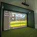 Golf simulator setup with screen displaying a golf course and a projector above.