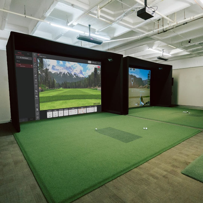 Indoor golf simulation room with screens displaying golf courses.