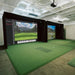 Indoor golf simulation room with screens displaying golf courses.