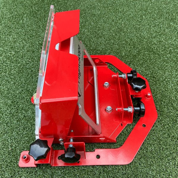 Red metal tool or device on a green grass background