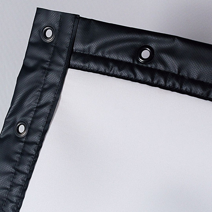 Close-up of a black tarp corner with grommets on a gray background