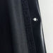 Close-up of a black car door panel with a button on a white background