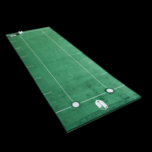 Green golf practice mat with white lines and golf accessories on a black background