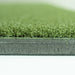 Close-up of green artificial grass with a white background